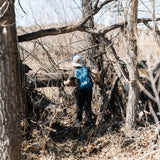 Child walking through wooded area