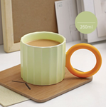 Handmade Ceramic Coffee Mug: Green with Orange Handle